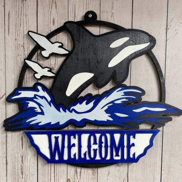 Layered orca welcome sign